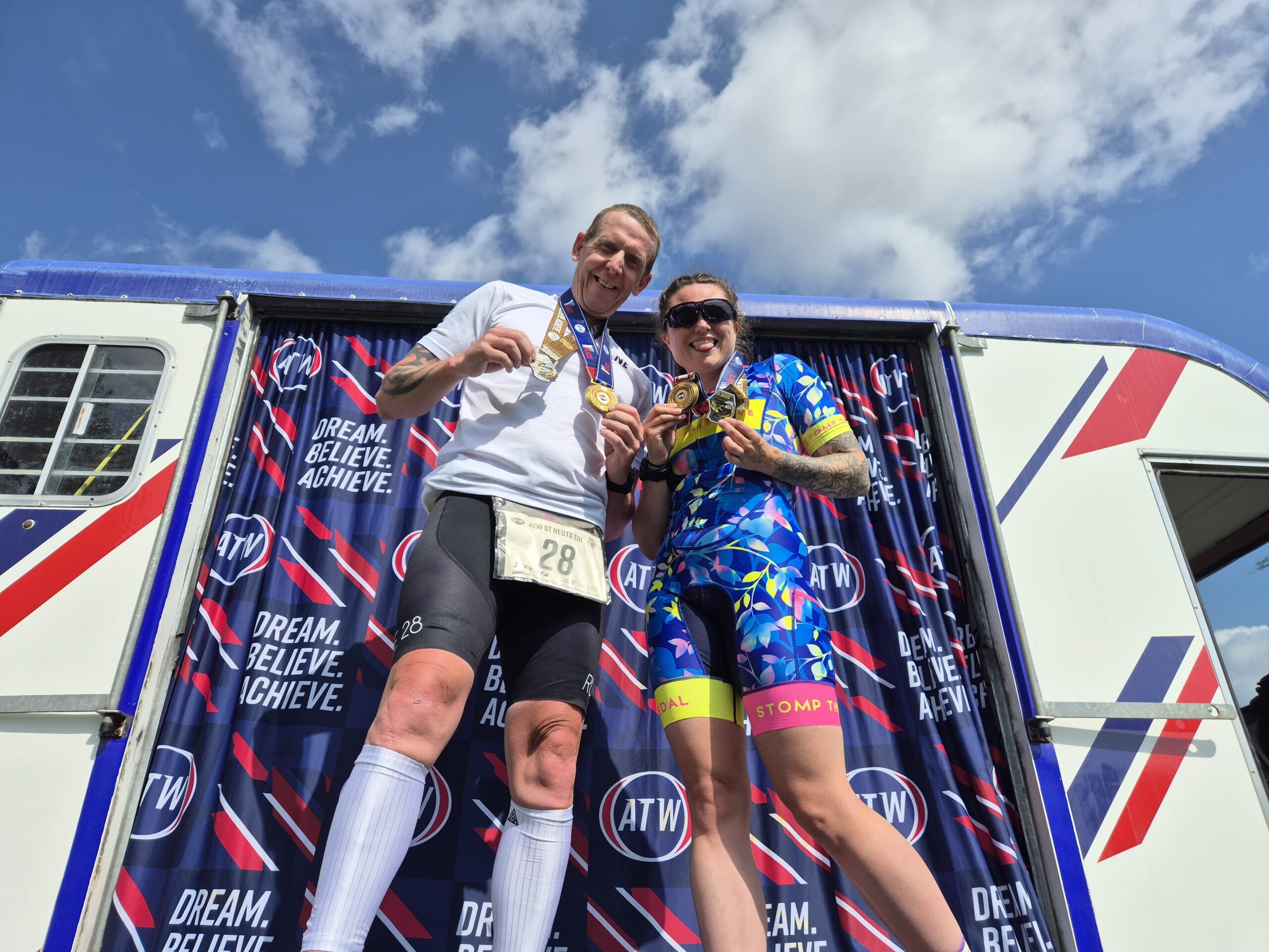 Hashtag coach Nick & athele Abi on the podium with their medals