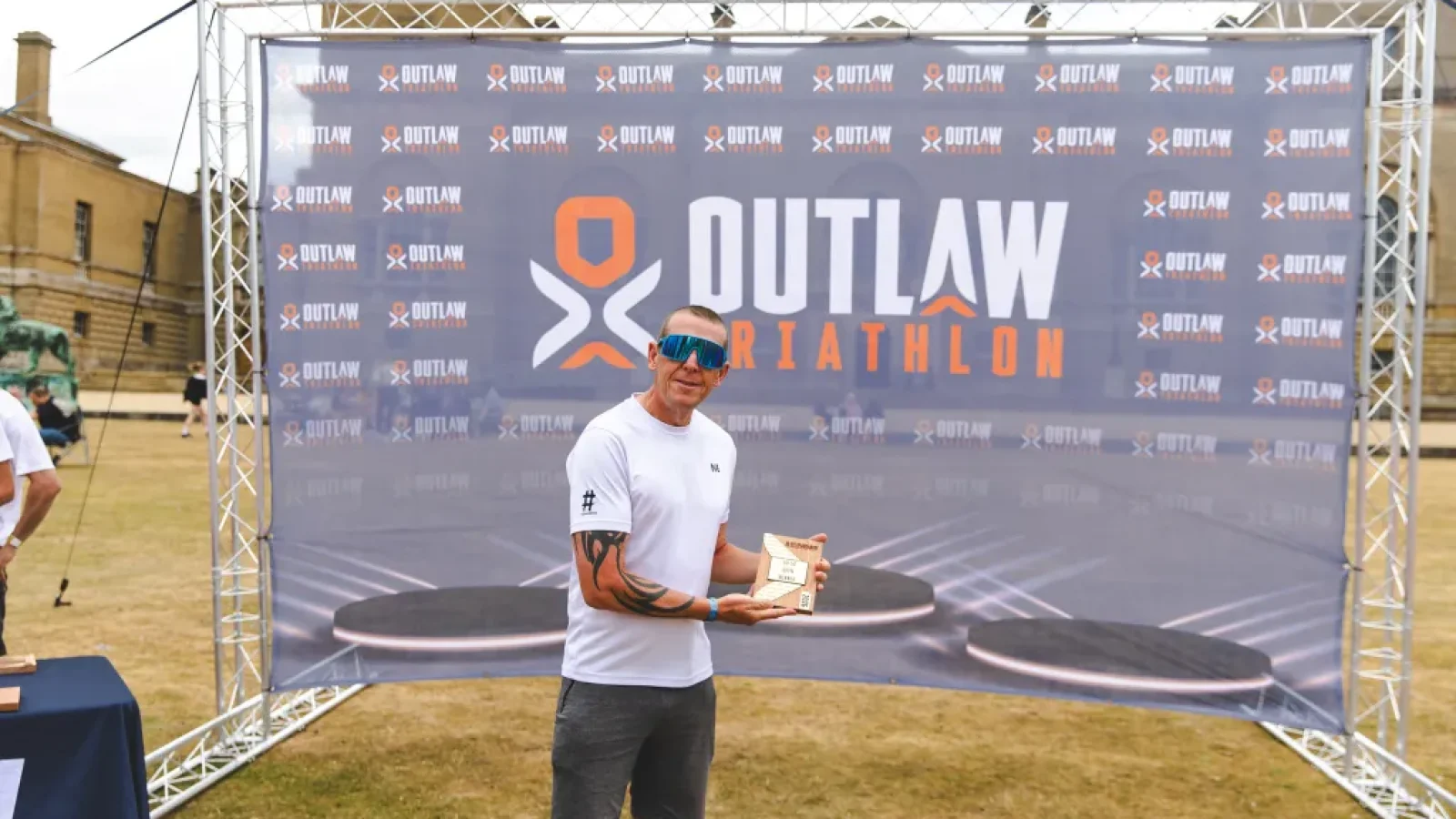 Hashtag Coaching head coach Nick on the Outlaw podium